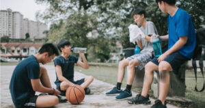 Young Players Resting After a Friendly Game Outdoors